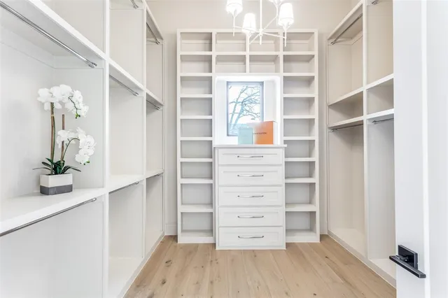a view of walk in closet with empty racks