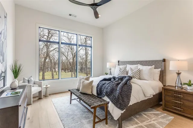 a spacious bedroom with a bed and a large window