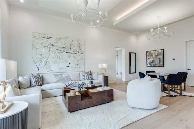 a living room with furniture and a chandelier