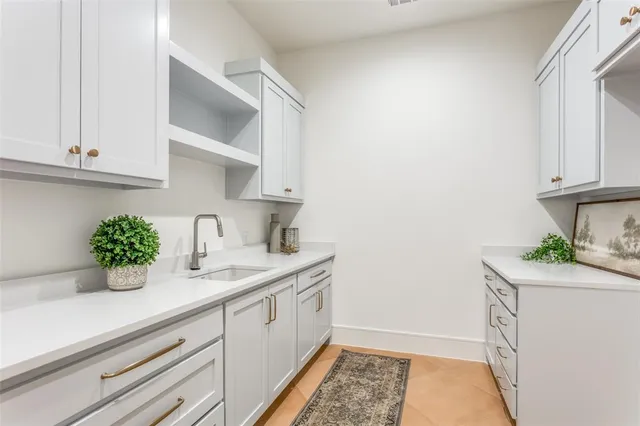 a kitchen with a sink and cabinets