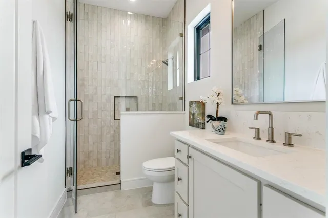a bathroom with a sink toilet and shower