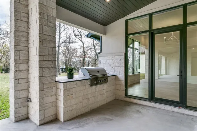 a hallway with a window and chandelier