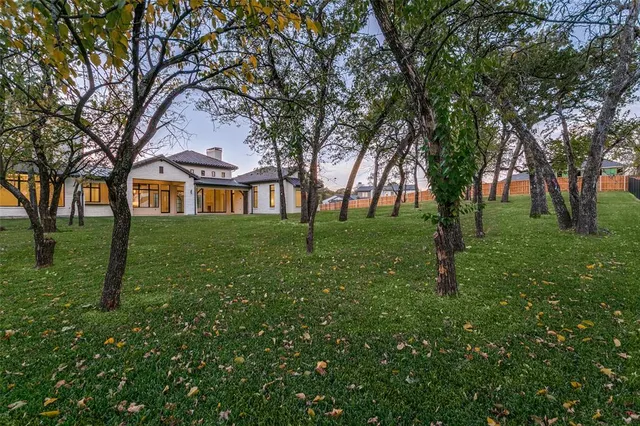 a huge green field with lots of trees