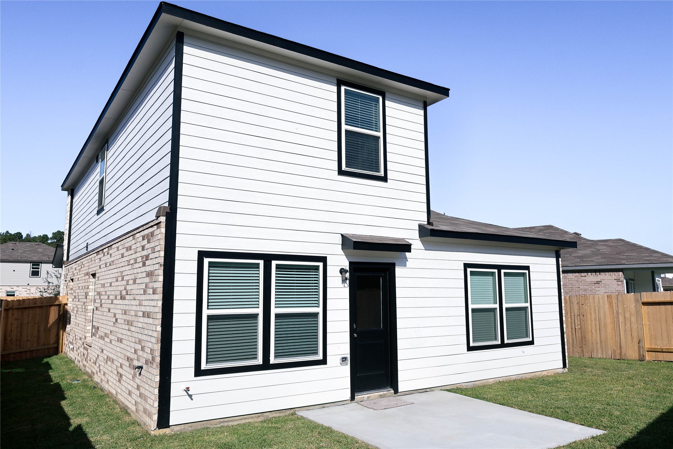 247 Brazen Forest Trail Magnolia, TX 77354 - Photo 12 of 18 a view of a white house with a large windows