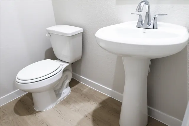 a white toilet sitting next to a bathroom sink