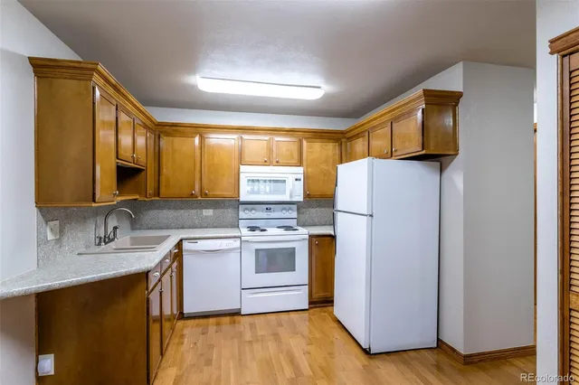 a kitchen with a sink cabinets and a refrigerator