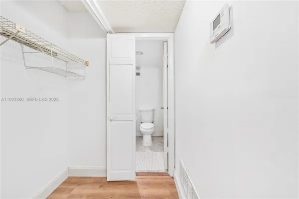 an empty room with closet and windows