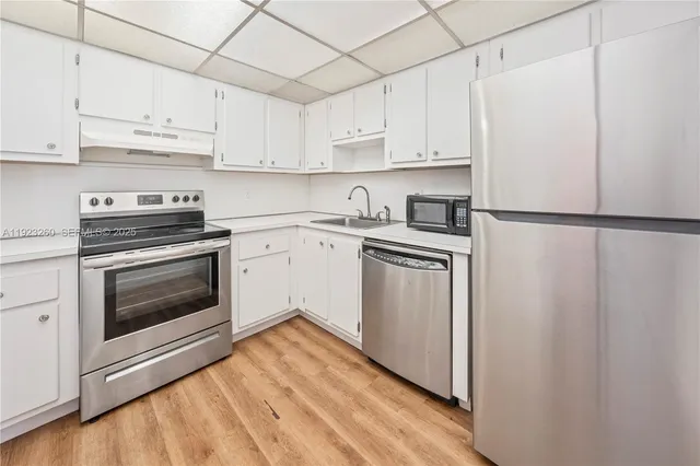a view of a kitchen with a stove and a refrigerator