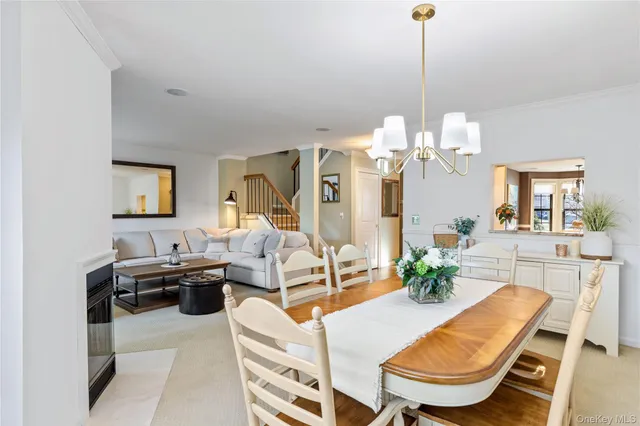 a living room with furniture a chandelier and a rug