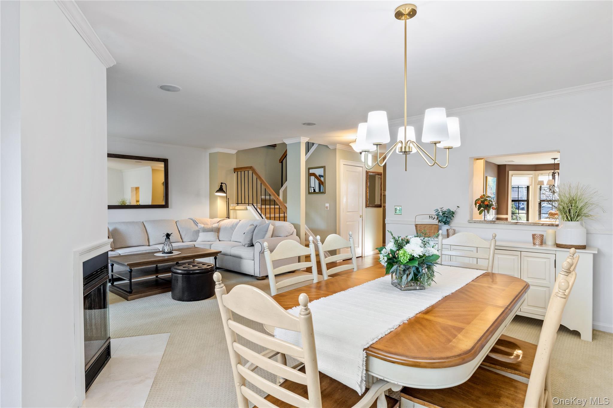 17 Sutton Place Islip, NY 11751 - Photo 15 of 32 Dining space featuring stairs, crown molding, a chandelier, and light colored carpet