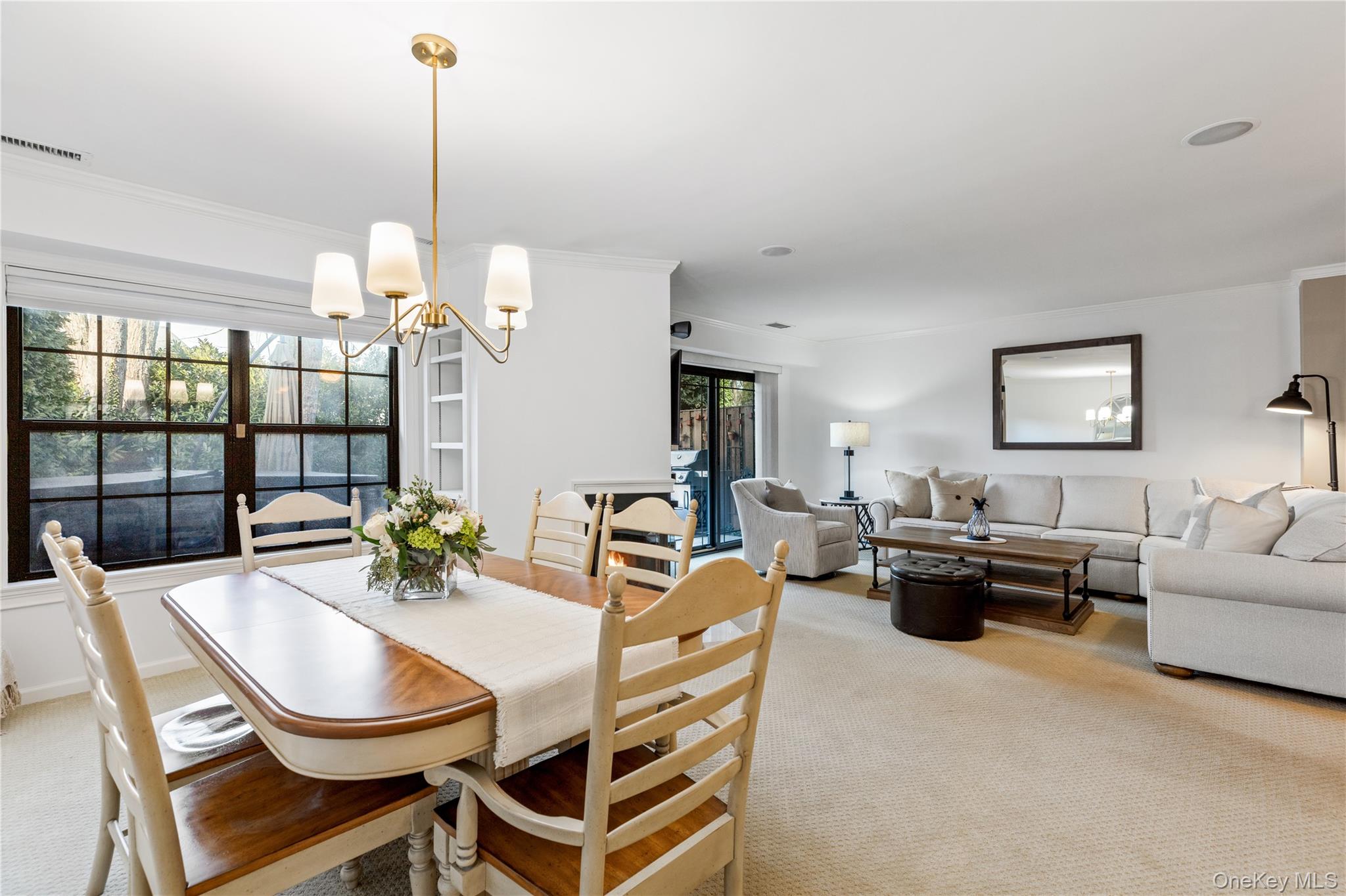 17 Sutton Place Islip, NY 11751 - Photo 16 of 32 Dining space featuring a chandelier, light carpet, and crown molding