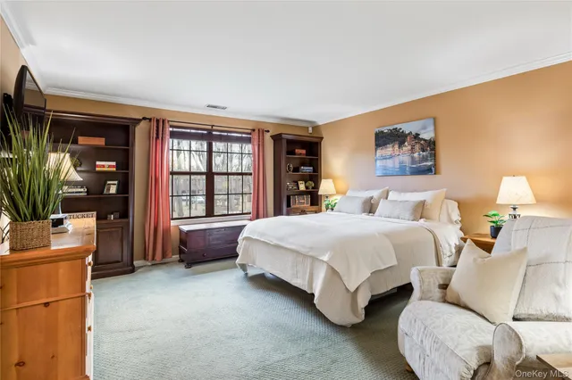 a spacious bedroom with a bed and a large window