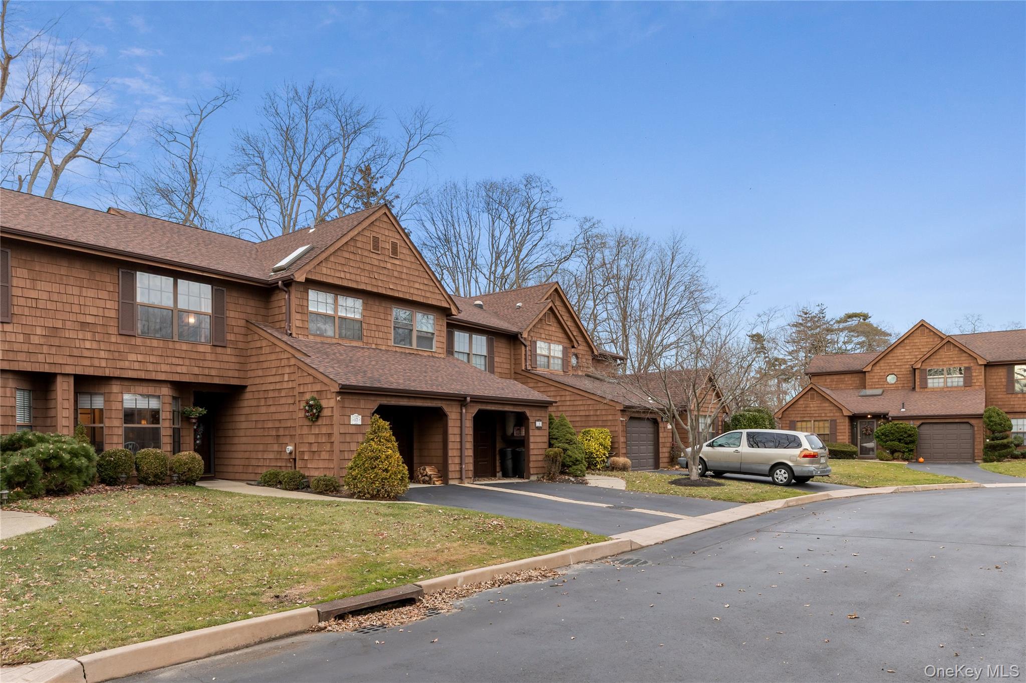 17 Sutton Place Islip, NY 11751 - Photo 2 of 32 Shingle-style home with asphalt driveway, roof with shingles, a residential view, a front yard, and an attached garage