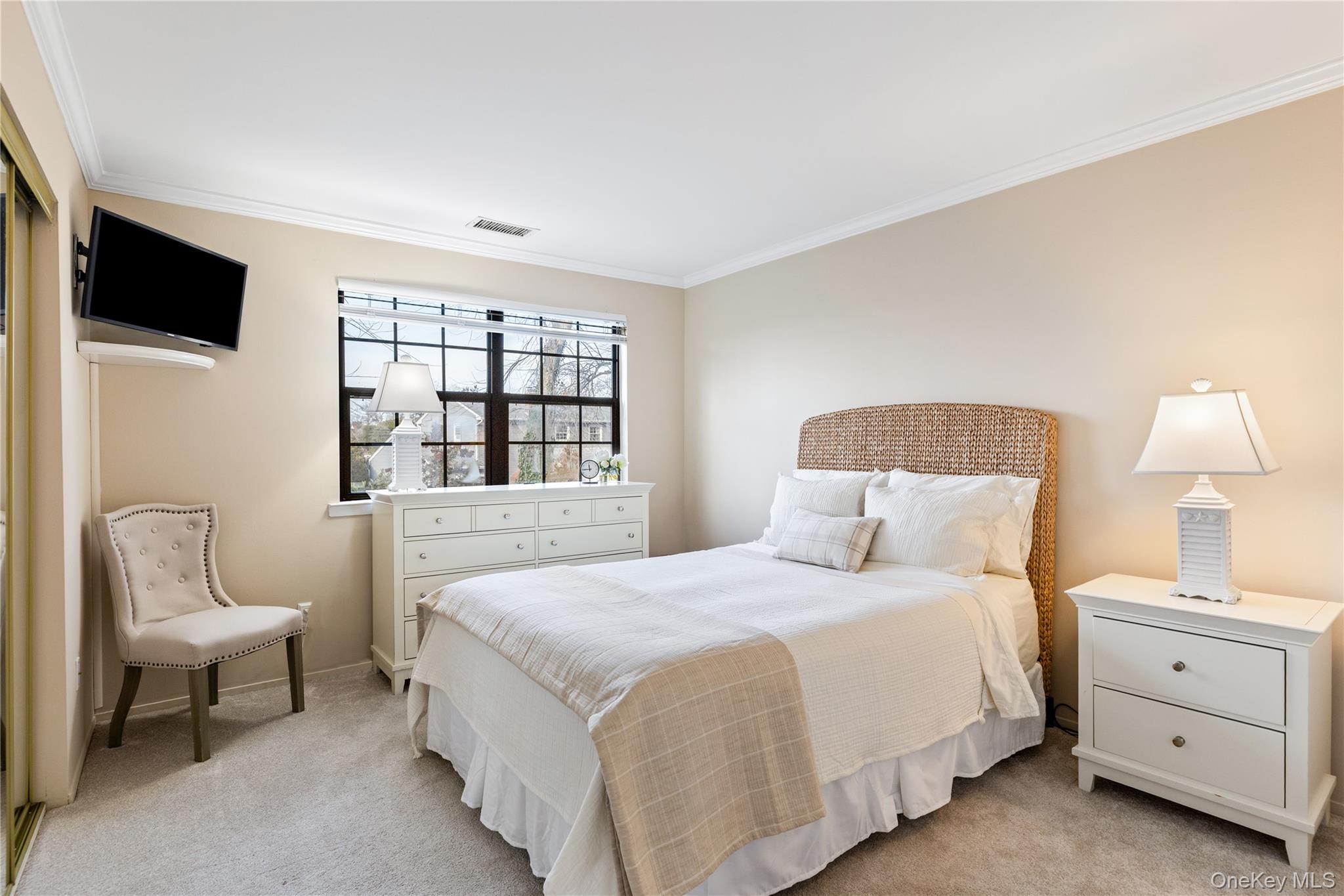 17 Sutton Place Islip, NY 11751 - Photo 24 of 32 Bedroom with light colored carpet and crown molding