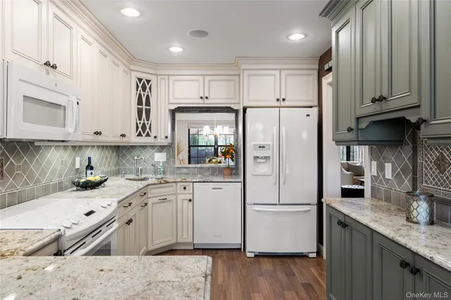 a kitchen with stainless steel appliances granite countertop a refrigerator sink and cabinets