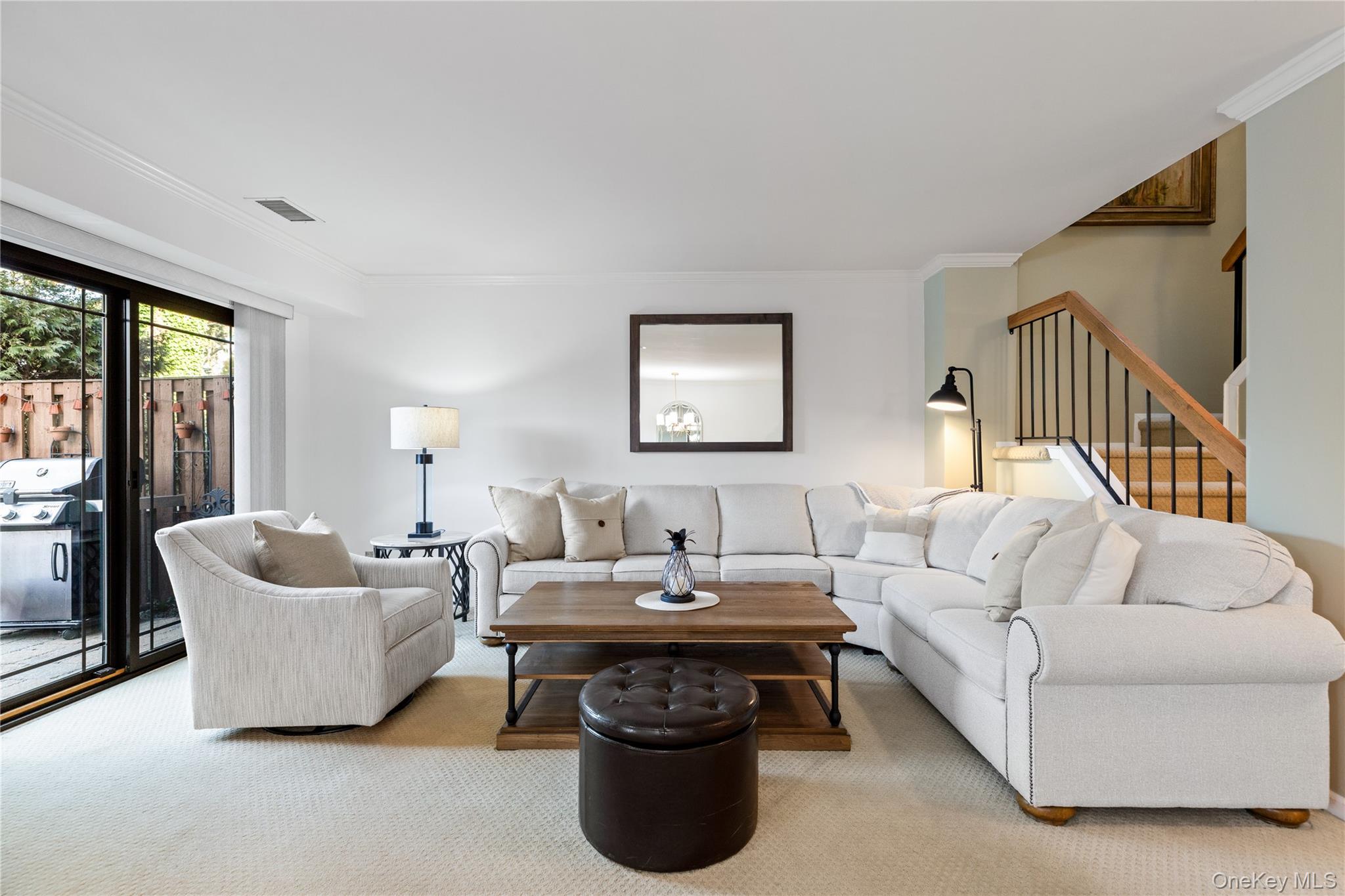 17 Sutton Place Islip, NY 11751 - Photo 9 of 32 Living room with ornamental molding, carpet floors, and stairway