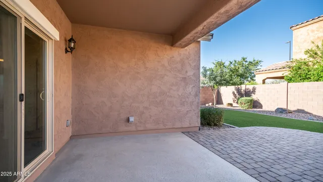a view of a dining room with furniture a rug and windows