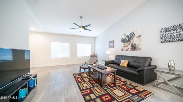 a living room with furniture rug and window