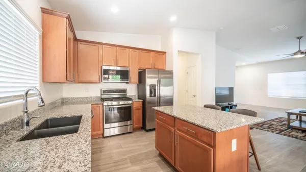 a kitchen with granite countertop a stove and a microwave
