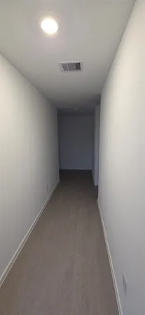 an empty room with a empty space and windows