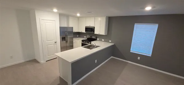 a kitchen that has a sink and a stove in it