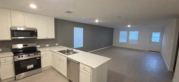 a kitchen that has a sink and a stove in it