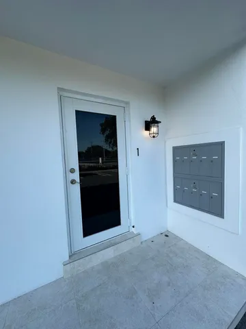 an empty room with closet and a mirror