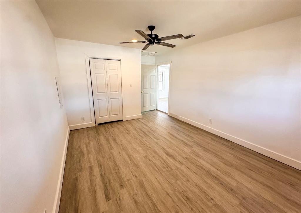 119 Autumn Drive Early, TX 76802 - Photo 16 of 29 wooden floor in a hall with an empty room