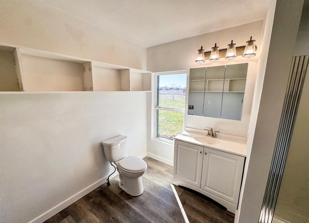 119 Autumn Drive Early, TX 76802 - Photo 18 of 29 a bathroom with a toilet sink and mirror
