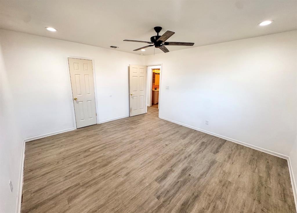 119 Autumn Drive Early, TX 76802 - Photo 21 of 29 a view of a room with wooden floor and a ceiling fan