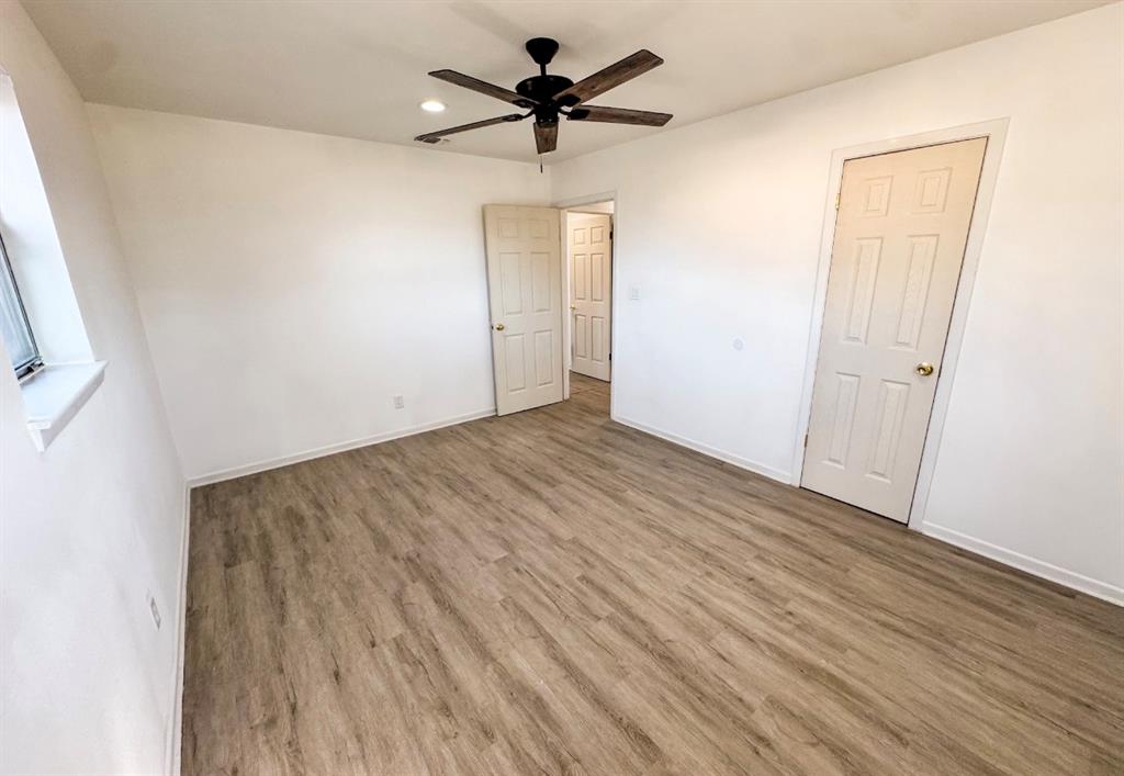 119 Autumn Drive Early, TX 76802 - Photo 23 of 29 wooden floor in an empty room with a window