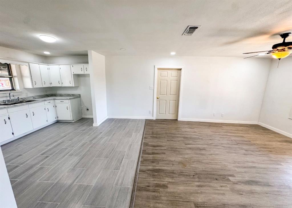 119 Autumn Drive Early, TX 76802 - Photo 7 of 29 a view of a kitchen with wooden floor and a sink