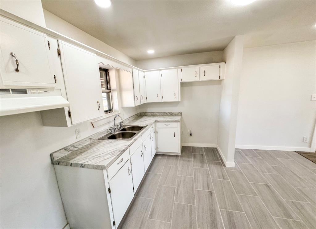 119 Autumn Drive Early, TX 76802 - Photo 9 of 29 a kitchen with a sink a stove a refrigerator and a microwave