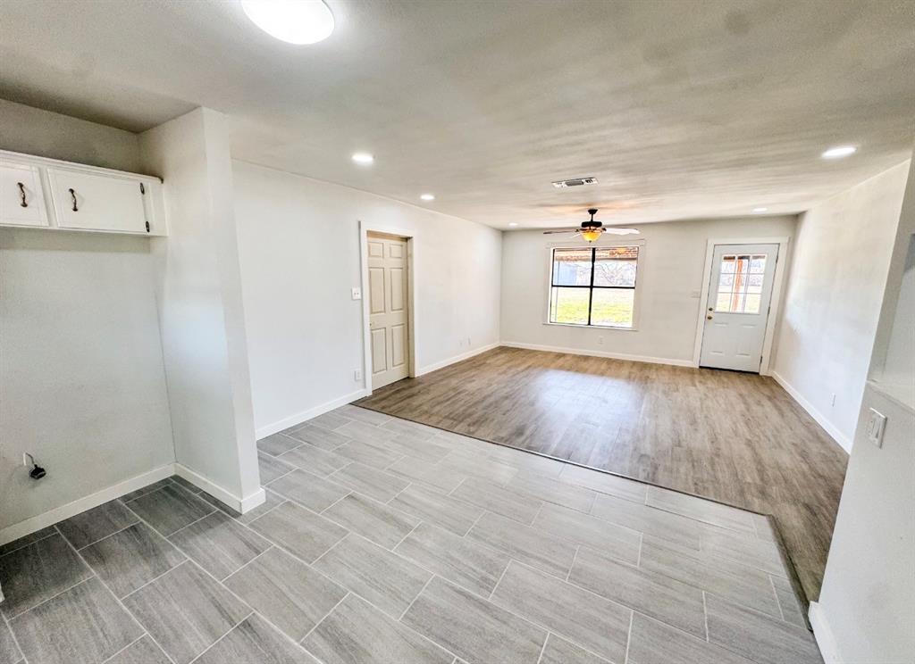 119 Autumn Drive Early, TX 76802 - Photo 10 of 29 an empty room with wooden floor and windows