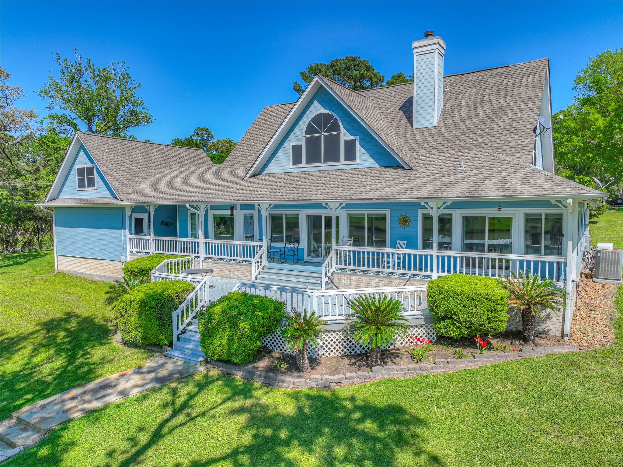 a front view of a house with a garden and plants