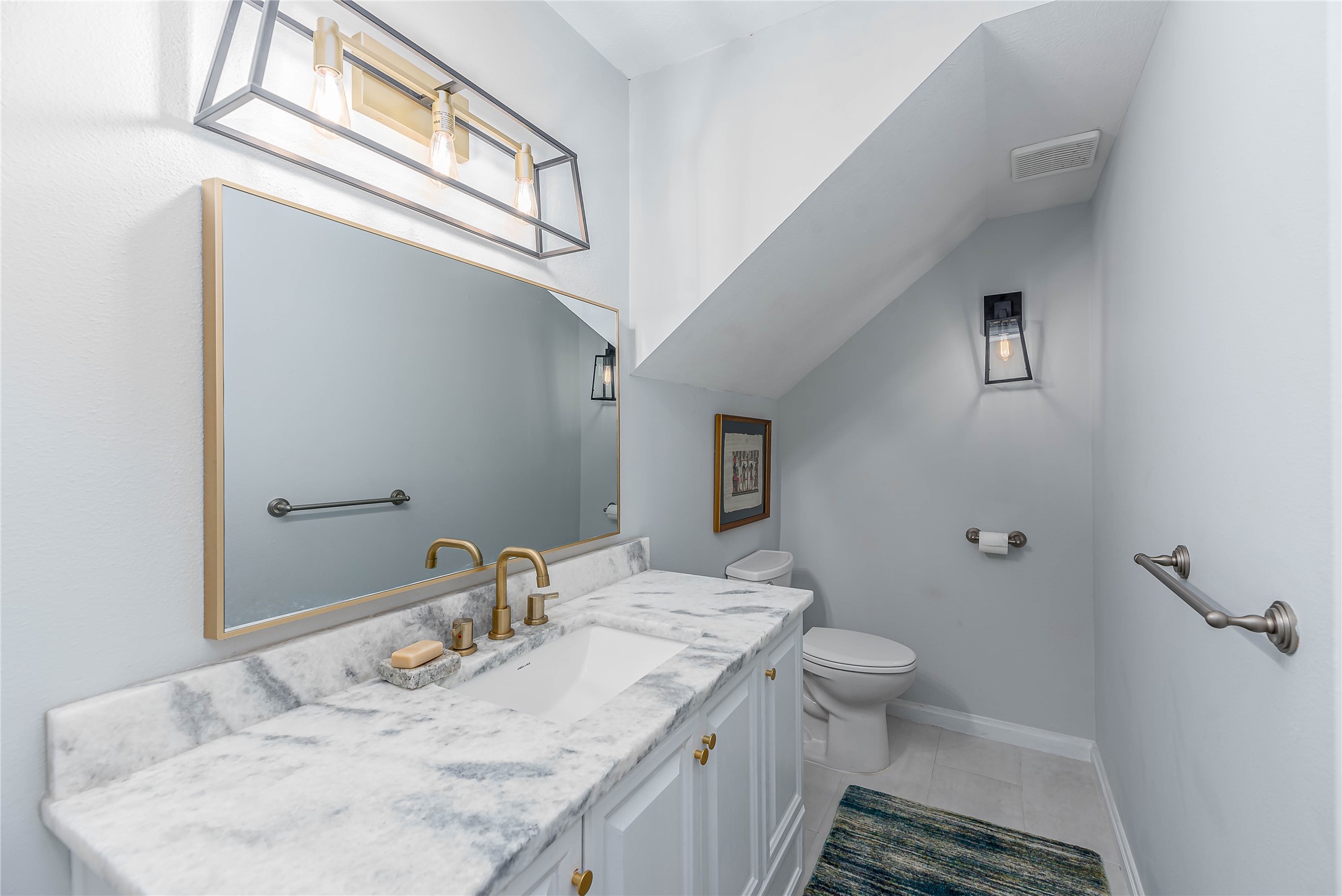 331 Memphis Belle Trinity, TX 75862 - Photo 15 of 50 a bathroom with a granite countertop sink a toilet and a mirror