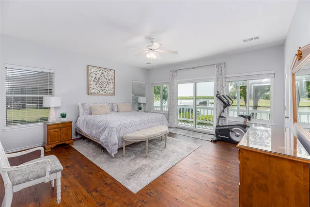 a bedroom with a bed and a large window