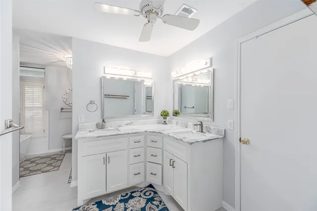 a spacious bathroom with a shower sink and mirror