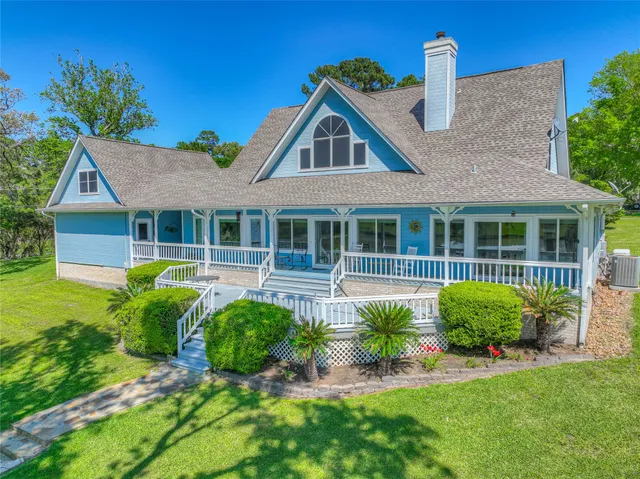 a front view of a house with a garden and plants