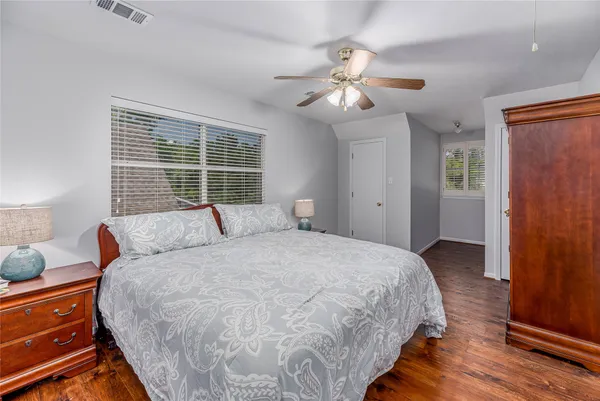 a spacious bedroom with a bed and a chandelier