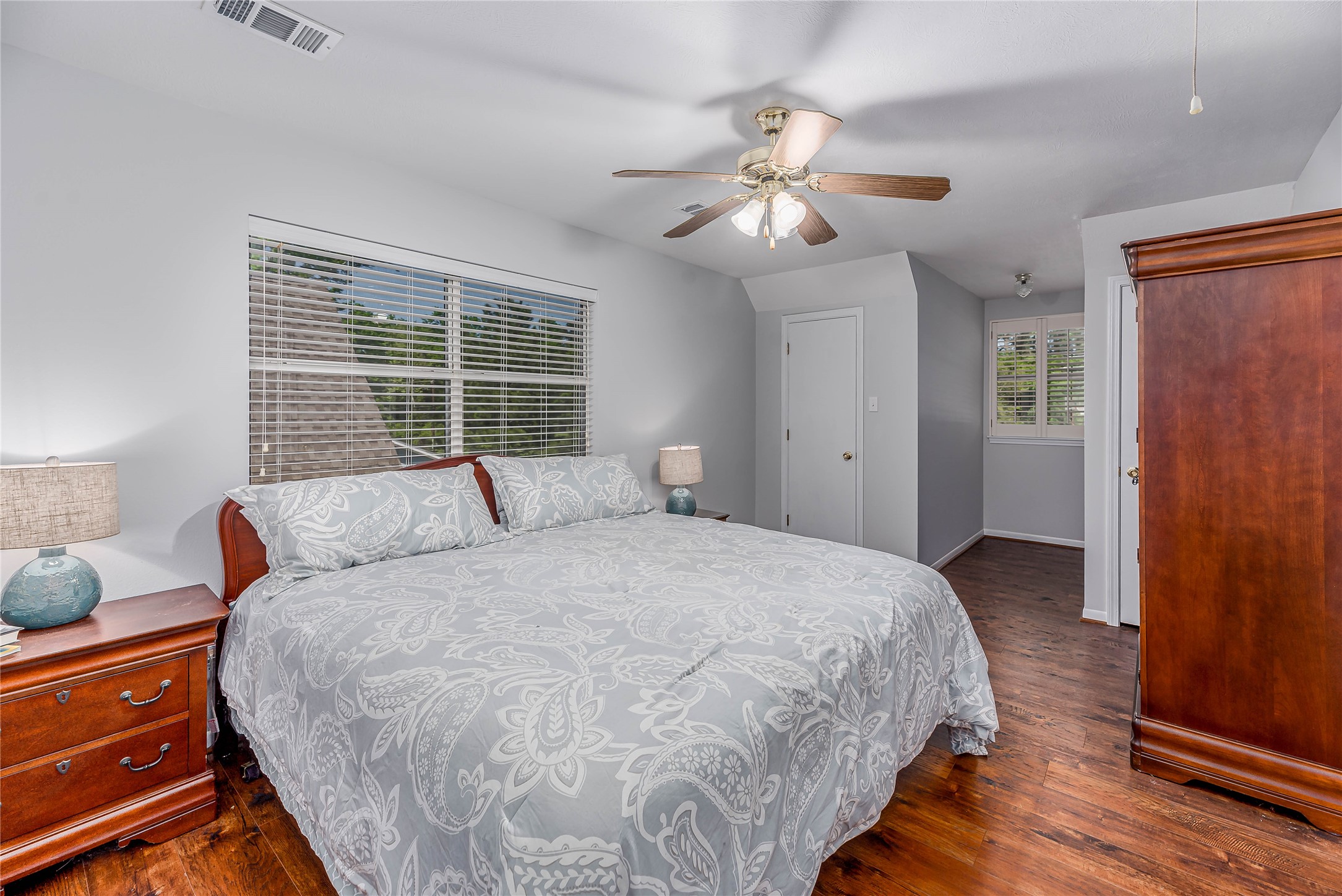 331 Memphis Belle Trinity, TX 75862 - Photo 21 of 50 a spacious bedroom with a bed and a chandelier
