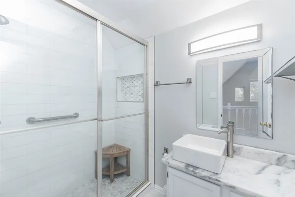 a bathroom with a granite countertop sink a toilet and a mirror