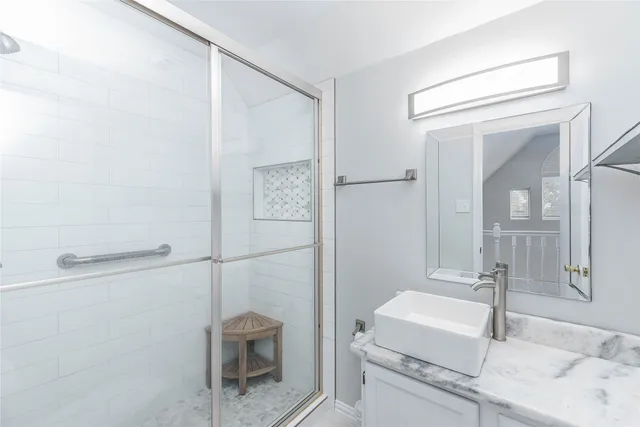 a bathroom with a granite countertop sink a toilet and a mirror