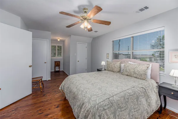a spacious bedroom with a bed and a table in it