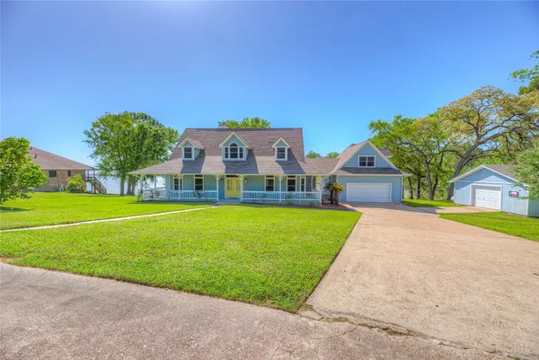 a front view of house with yard and green space