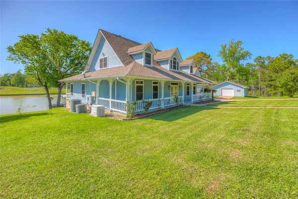 a front view of a house with a garden and deck