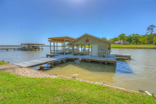 a view of a house with pool and a yard