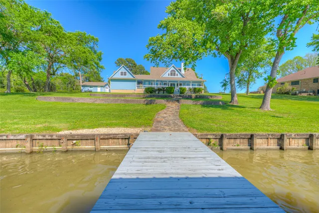 a view of swimming pool with garden and trees