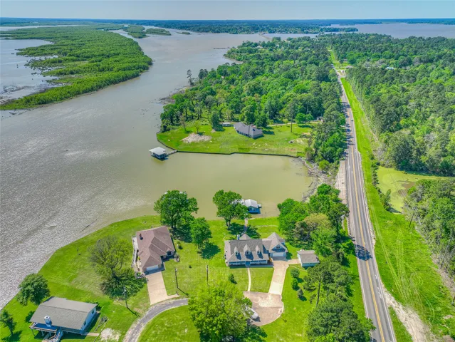an aerial view of a house with a yard and outdoor seating