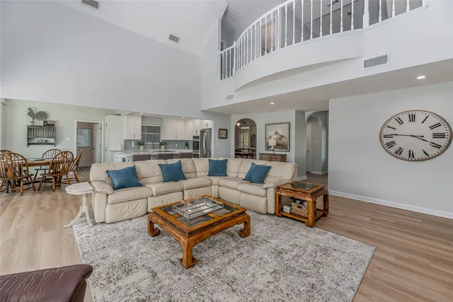 a living room with furniture a rug and a wall painting